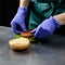 Unidentified chef preparing veggie burger with yummy vegetable p