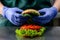 Unidentified chef preparing veggie burger with yummy vegetable p