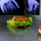 Unidentified chef preparing veggie burger with yummy vegetable p