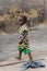 Unidentified Dagomban barefoot boy walks in the local village.