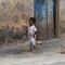 Unidentified Dagomban barefoot girl walks in the local village.