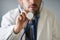 An unidentified doctor grabs a stethoscope to the camera to check the patient