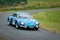 Unidentified drivers on a blue vintage Alpine Renault racing car