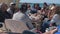 Unidentified family and their friends dine at a seaside restaurant on a Mediterranean beach