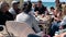 Unidentified family and their friends dine at a seaside restaurant on a Mediterranean beach