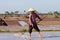 An unidentified farmers are harvesting salt