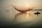 Unidentified fisherman checks his nets in early morning on river in Hoian, Vietnam