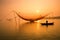 Unidentified fisherman checks his nets in early morning on river in Hoian, Vietnam