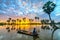 Unidentified fishers sit on a boat watching the dawn greeting the new day