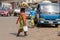 Unidentified Ghanaian woman carries a basin with pineapples on