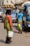 Unidentified Ghanaian woman carries a basin with pineapples on