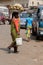 Unidentified Ghanaian woman carries a basin with pineapples on