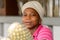 Unidentified Ghanaian woman sits in front of pineapples in loca