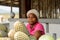 Unidentified Ghanaian woman sits in front of pineapples in loca