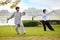 Unidentified group of people practice Chinese sword with Tai Chi Chuan in a park