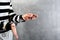 unidentified hands of prisoner in prison stripped uniform standing in handcuffs and holding a key in the dark interrogation