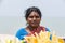 Unidentified Indian trader woman in her shop on local market selling all kind of goods, fuits, vegetables