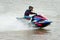 Unidentified jet ski racer at Jet ski pro tour #3, Udonthani, Thailand - May 25, 2019: Jet Ski competitor cornering at speed