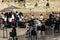 Unidentified Jews women watching through the fence to the female sector of the conduct Bar Mitzvah ceremony near Western Wall