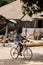 Unidentified local boy rides a bicycle in a village in Guinea B