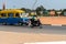 Unidentified local man in helmet rides a motorcycle in a villag