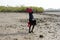 Unidentified local man walks with bags on the coast of the Oran