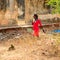 Unidentified local pregnant woman in red dress drinks something