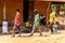 Unidentified local three men walk in a village in Guinea Bissau