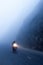 An unidentified male riding motorcycle on the dark misty mountain road, mystic asphalt road in mountain gorge