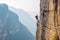 Unidentified man climbing steep mountain via ferrata Generative AI
