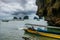 Unidentified man navigate on his boat to transport tourist over the Phang Nga National Park, Thailand
