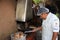 Unidentified Man at the Restaurant Pachapacha in Cusco. He grills Guinea Pig Ã¢â‚¬â€œ the traditional Meal in Peru