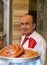 Unidentified Man selling Turkish Churro Halka Tatli at Dessert Shop