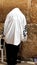 Unidentified man in tefillin praying at the Wailing wall (Western wall)