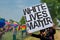 Unidentified Masked Protestor Holding White Lives Matter Banner at Hudson Pride