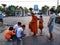 Unidentified monk receive food offering from people in bangkok