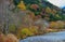 the unidentified mountain resort hotel in the background of Azusa river and colorful autumn trees at Kamikochi, Nagano pref.