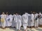 Unidentified Muslim pilgrims in white ihram touch black cloth of