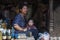 Unidentified Nepalese Newari woman with her child in a haberdashery in Bhaktapur, listed as a World Heritage by UNESCO