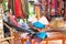 Unidentified Padaung (Karen) tribe woman weave on traditional device near Mae Hong Son, Thailand