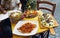 Unidentified people eating traditional italian food in outdoor restaurant