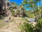 Unidentified people enjoy swimming, relaxing at Honey Creek where it tumbled over Bridal Veil Falls upstream from Turner Falls,