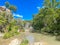 Unidentified people enjoy swimming, relaxing at Honey Creek where it tumbled over Bridal Veil Falls upstream from Turner Falls,