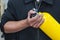 Unidentified people holding yellow oxygen tank. Man prepare and