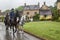 Unidentified people and horses near cottages in the village of Stanton, Cotswolds district of Gloucestershire.