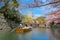 Unidentified people ride Himeji boat tour around the outer moat of Himeji castle during full bloom