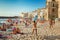 Unidentified people on sandy beach in Cefalu, Sicily, Italy