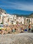 Unidentified people on sandy beach in Cefalu, Sicily, Italy