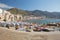 Unidentified people on sandy beach in Cefalu, Sicily, Italy