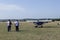 Unidentified people visit small sports planes at the aviation rally, Stanesti aerodrome, Gorj, Romania